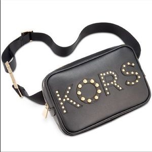 A studded KORS logo belt bag
